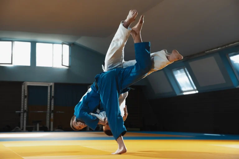 two young judo fighters kimono training martial arts gym with expression action motion Web H scaled